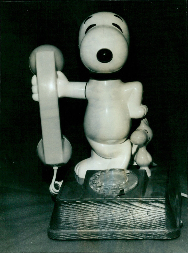 A museum visitor admires a 1970s-era telephone at the Museum of Old Telephones in Oxford. - Vintage Photograph