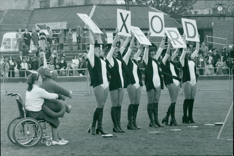 Oxford's cheerleaders perform a routine at Cambridge. - Vintage Photograph