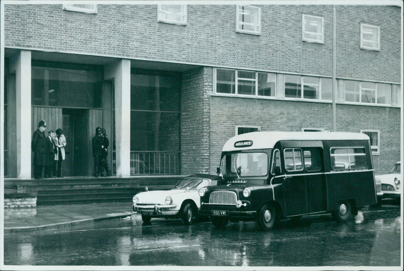 An ambulance parked outside of the City & County Ainaaban Biel in November 1969. - Vintage Photograph