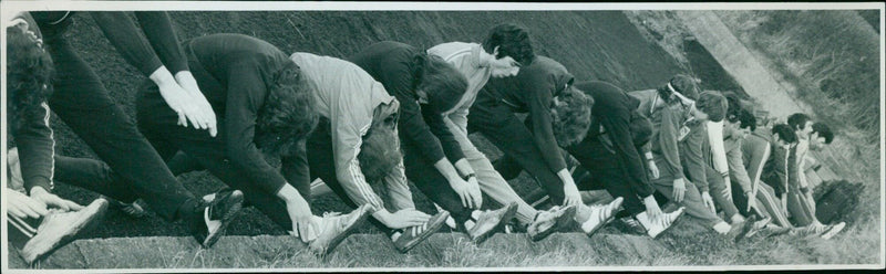 A young athlete competes in a track and field event. - Vintage Photograph