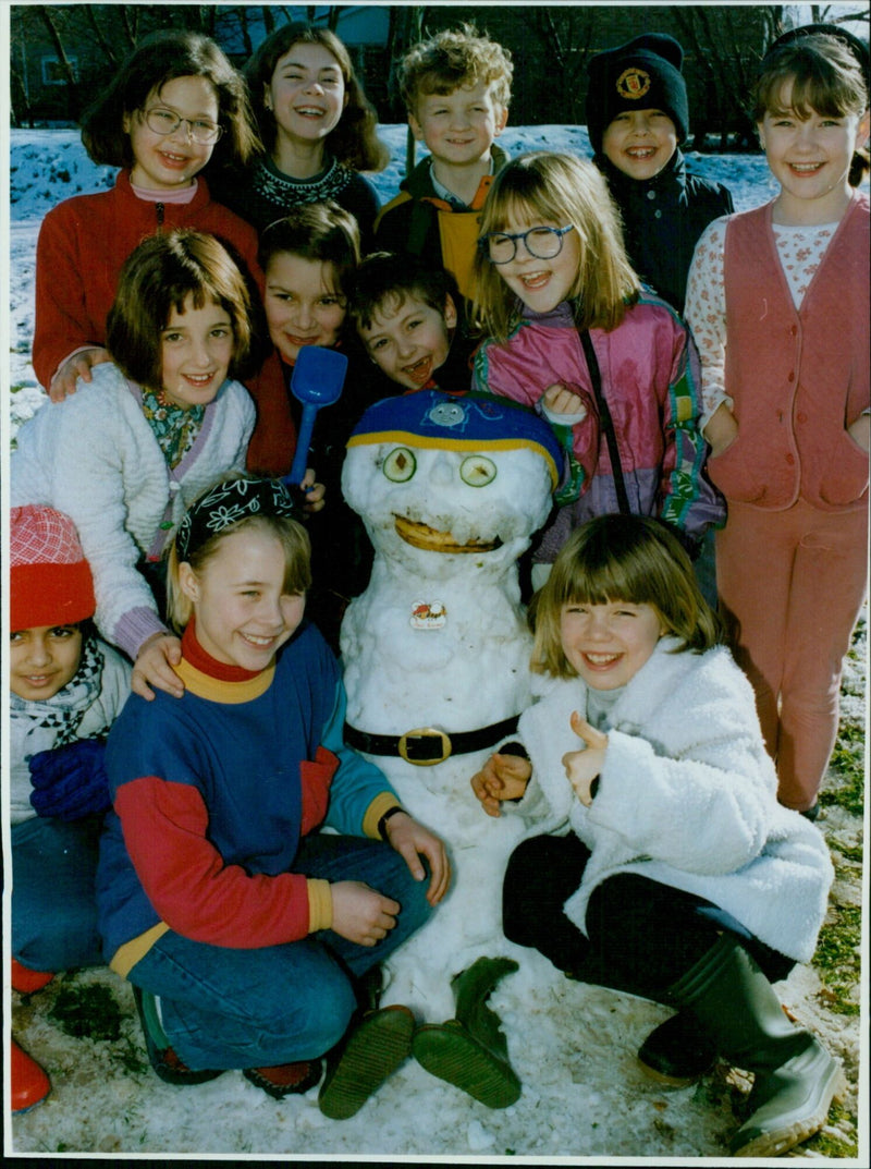 Year 4 students from St Ebbes Infant School build a snowman for 4 year old Sam Popham. - Vintage Photograph