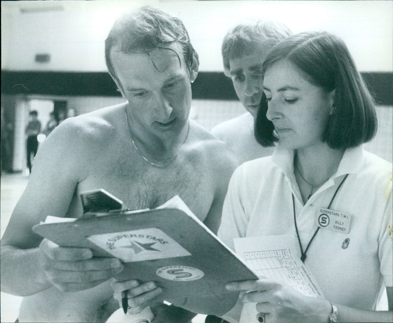 Bill Athey checks his time at the ASTARS Superstars Twi-Gilly Tierney event. - Vintage Photograph