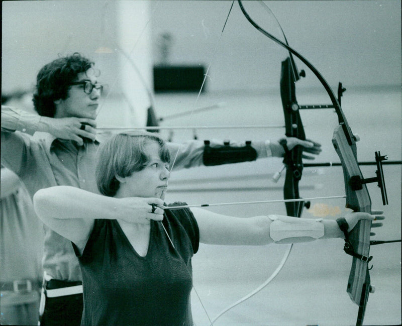 Archer Carol Levick takes aim in the University gym. - Vintage Photograph