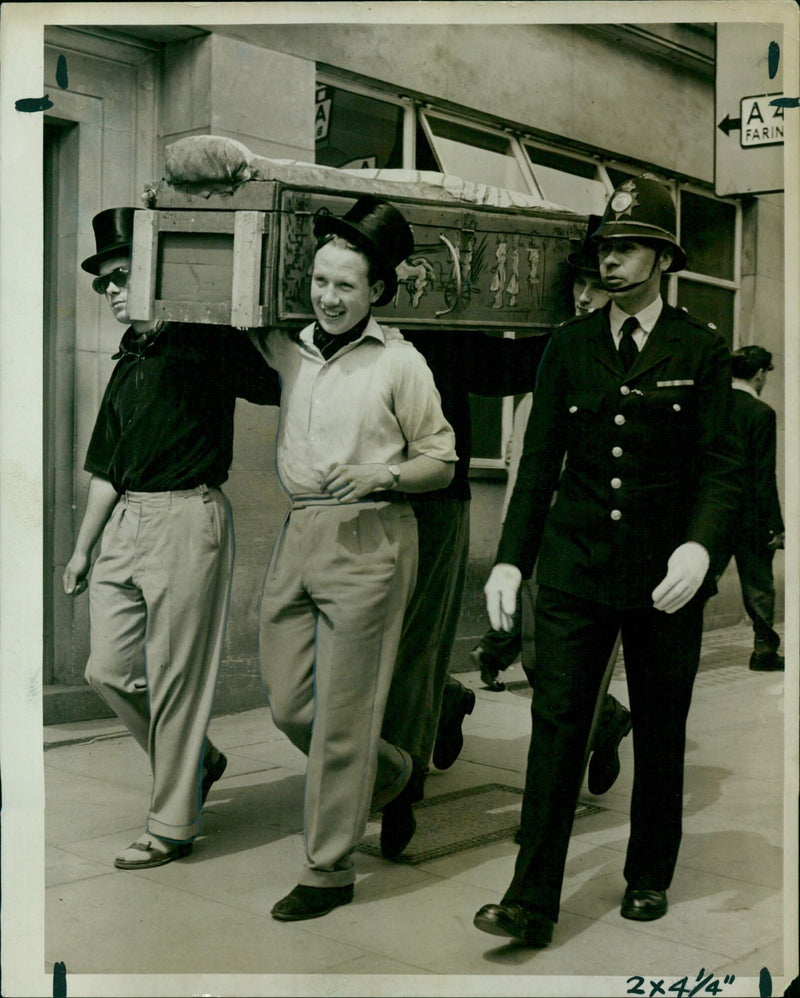 Four St. John's College undergraduates march with an Egyptian mummy-case in Oxford. - Vintage Photograph