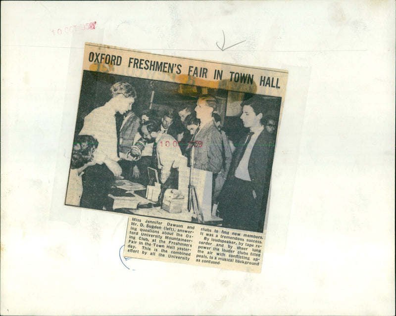 Miss Jennifer Dawson and Mr. D. Sugden answer questions about the Oxford University Mountaineering Club at a Freshmen's Fair in the Town Hall. - Vintage Photograph