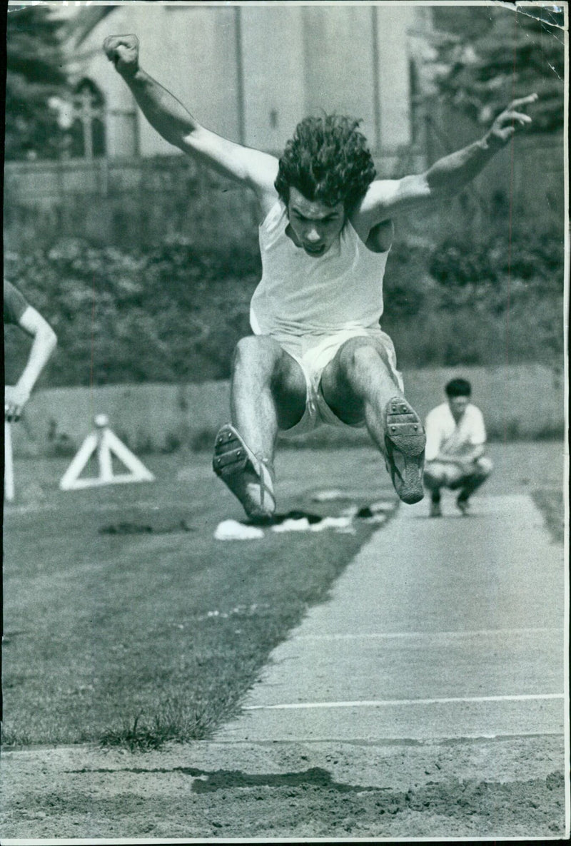 Athletes competing in the long jump event at an Oxford University track and field meet. - Vintage Photograph