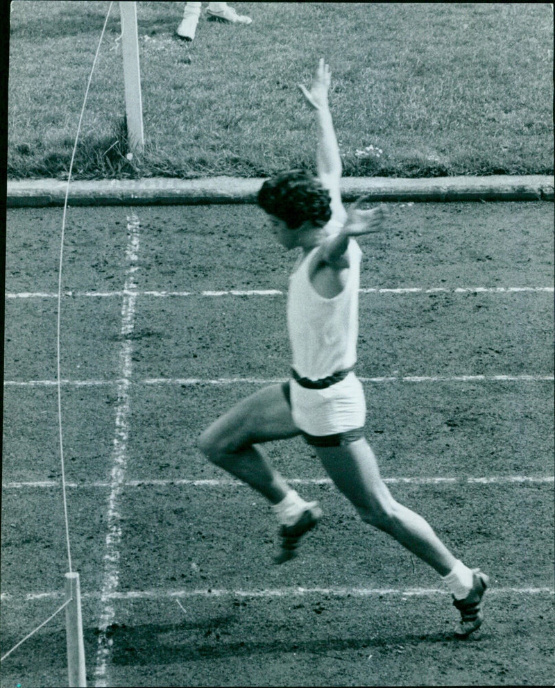 Student athlete S.E.H. Coats celebrates his victory in the 100 yards race at the O.U.A.C. Cupper's Final. - Vintage Photograph