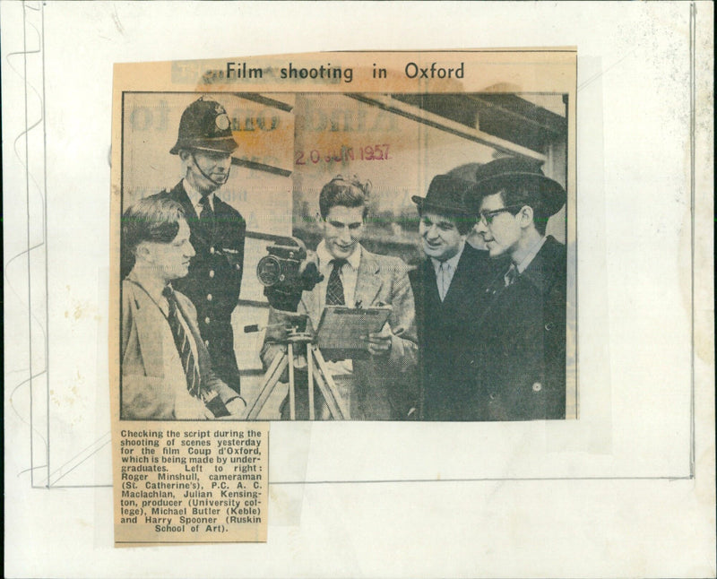 Actors and crew check the script during a film shoot in Oxford. - Vintage Photograph