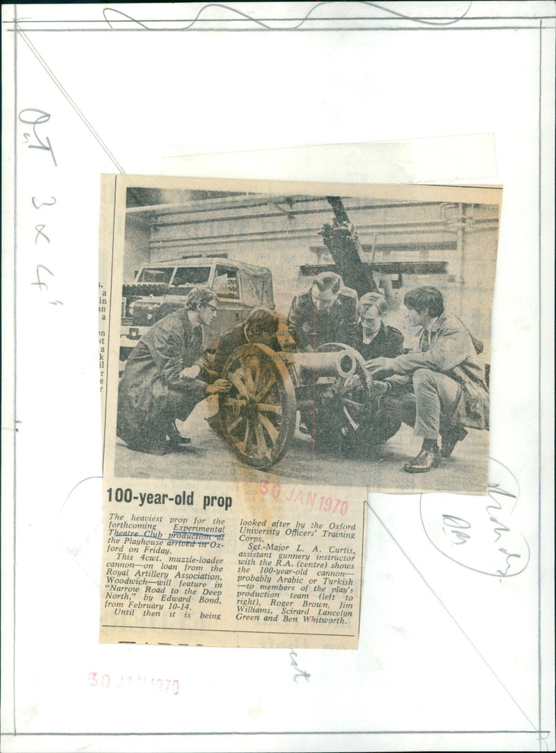 Sgt.-Major L. A. Curtis of the Royal Artillery Association shows a 100-year-old cannon to members of the production team of "Narrow Road to the Deep North." - Vintage Photograph