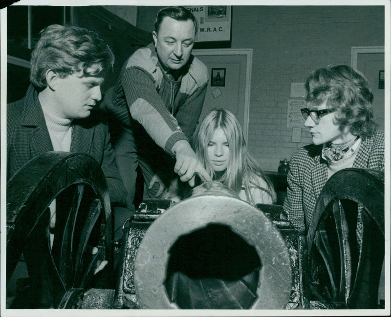 Mary Eimington, an undergraduate at Somerville College, prepares to fire a hundred-year-old cannon, which is to feature in the forthcoming Experimental Theatre Club production of Narrow Road to the Deep North. - Vintage Photograph