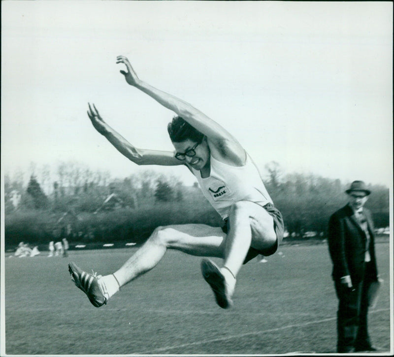 Long jumper Peter de Villiers jumps in Trinity College, Oxford, on April 9, 1969. - Vintage Photograph