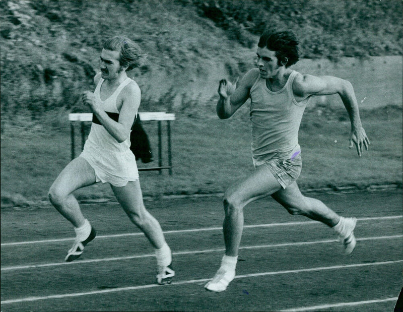 Runners compete in the 200m track event. - Vintage Photograph