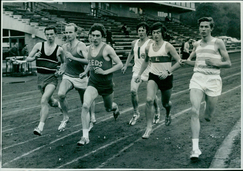 Athletes compete in the One Mile race at the Oxford University Seniors & Freshmen Trials. - Vintage Photograph