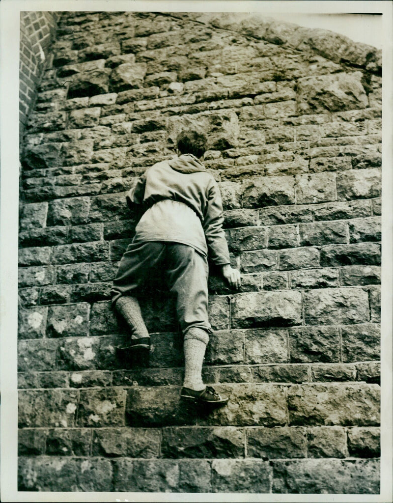 A member of the Mountioneering Club stands atop a peak in June, 1957. - Vintage Photograph