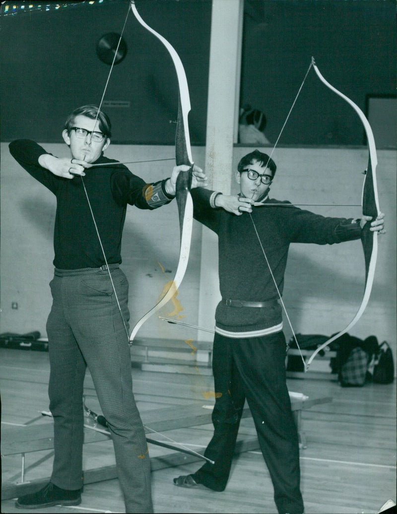 Two archers practice their sport at the Oxford Mail Archery Feature. - Vintage Photograph