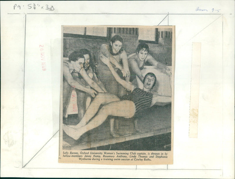 Sally Barnes, Oxford University Women's Swimming Club captain, is thrown in by fellow members during a training swim session at Cowley Baths. - Vintage Photograph