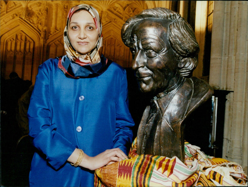 Leila Aboulela, winner of the Caine Prize for African Writing, poses with a bust of Sir Michael Caine. - Vintage Photograph