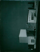 A woman wearing a traditional Pakistani dress poses in front of a puppet theater. - Vintage Photograph
