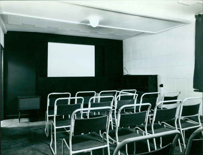 Four members of a construction team building a soundproofed wall with a variable screen. - Vintage Photograph