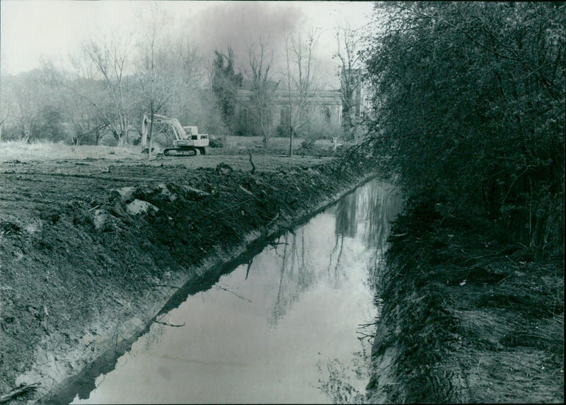 A group of workers fill the moat of a castle. - Vintage Photograph