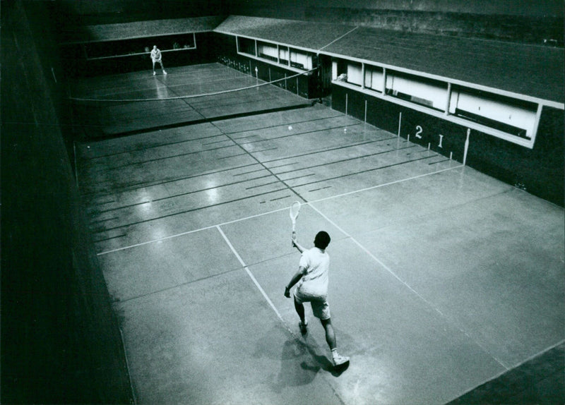 Players compete in a game of Real Tennis at Meton eslege in Oxford. - Vintage Photograph