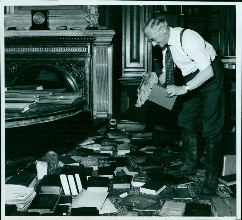 Mr. R.C Maasz repairing a damaged book at the Institute after yesterday's flooding. - Vintage Photograph