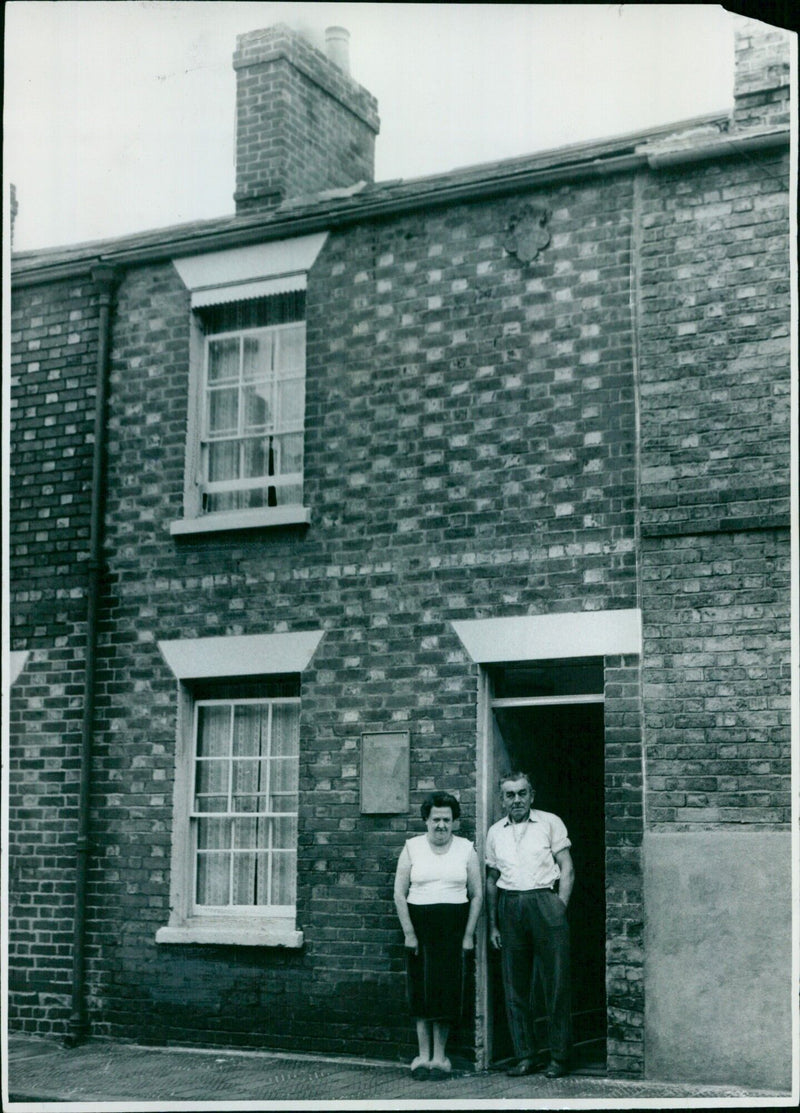 Mr. and Mrs. E. C. Robbins standing outside their home in Jericho, England. - Vintage Photograph