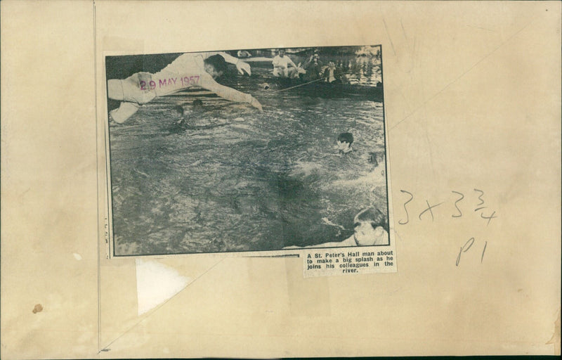 A man plunges into the water at St. Peter's Hall on May 29th, 1957. - Vintage Photograph