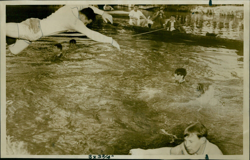 A man plunges into the water at St. Peter's Hall on May 29th, 1957. - Vintage Photograph