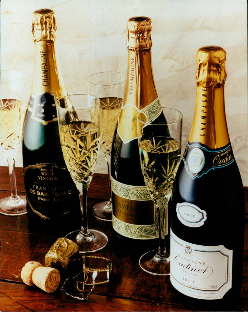 A bottle of Champagne Chan B Premi Te Brut Vintage sits among champagne glasses in a London store. - Vintage Photograph