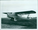 A Beagle A.61 Terrier aircraft is seen on the runway, demonstrating its reliability, versatility, and quiet cruising capability. - Vintage Photograph