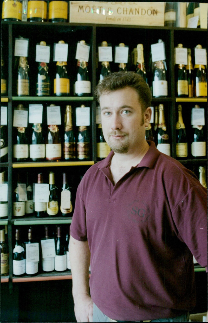 Richard Harrop, Manager of Stevens Garnier Ltd wine merchants, holds a bottle of Moët & Chandon Fondin 1743 SC. - Vintage Photograph