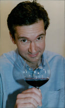 Wine expert John Stimfig tasting a variety of wines and spirits. - Vintage Photograph
