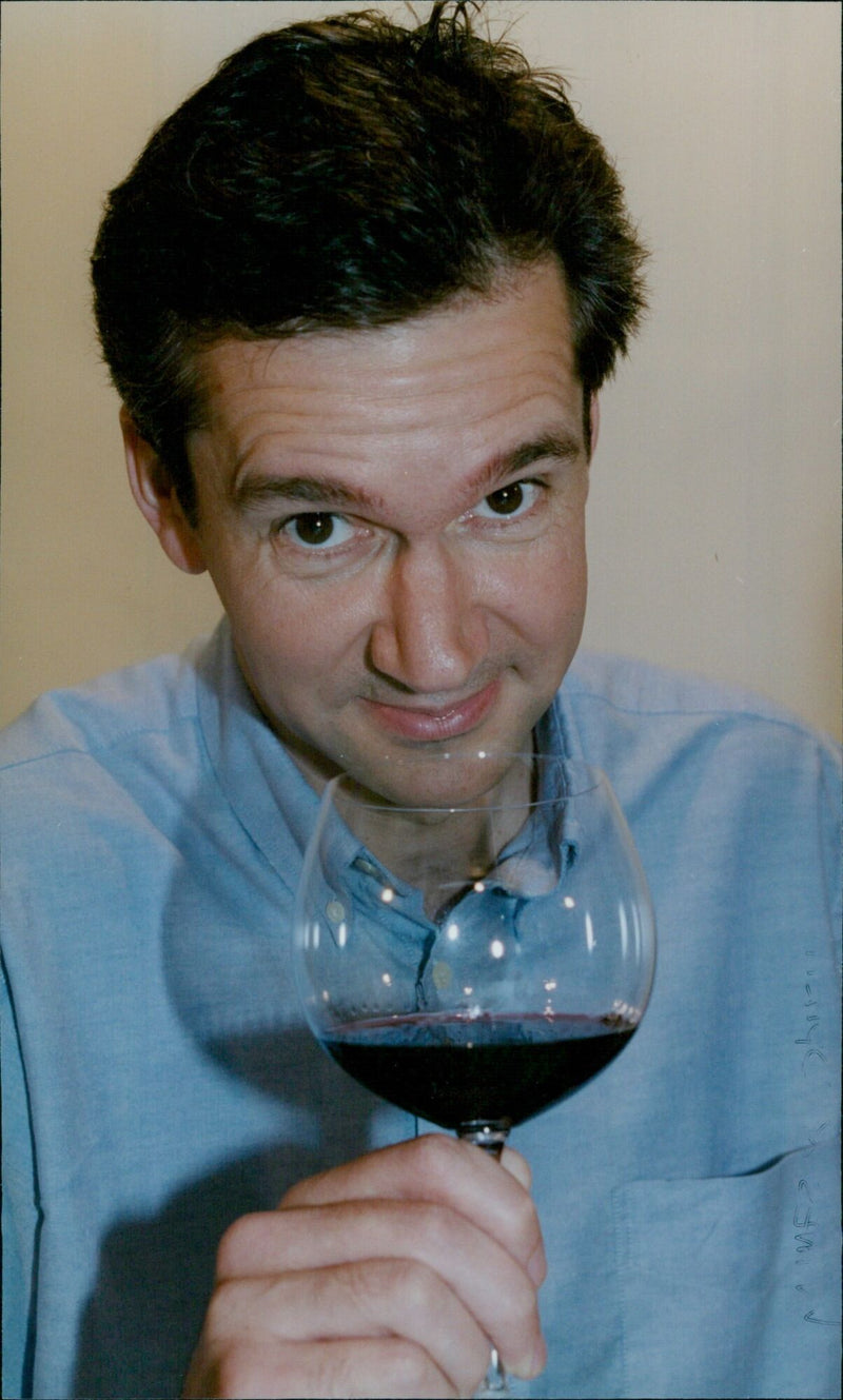 Wine expert John Stimfig tasting a variety of wines and spirits. - Vintage Photograph