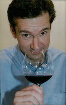 Wine expert, John Stimfig, samples some wines and spirits. - Vintage Photograph