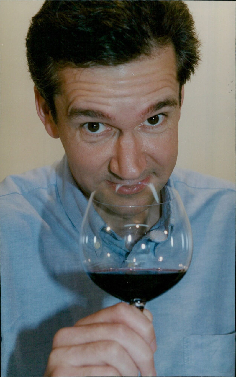 Wine expert, John Stimfig, samples some wines and spirits. - Vintage Photograph