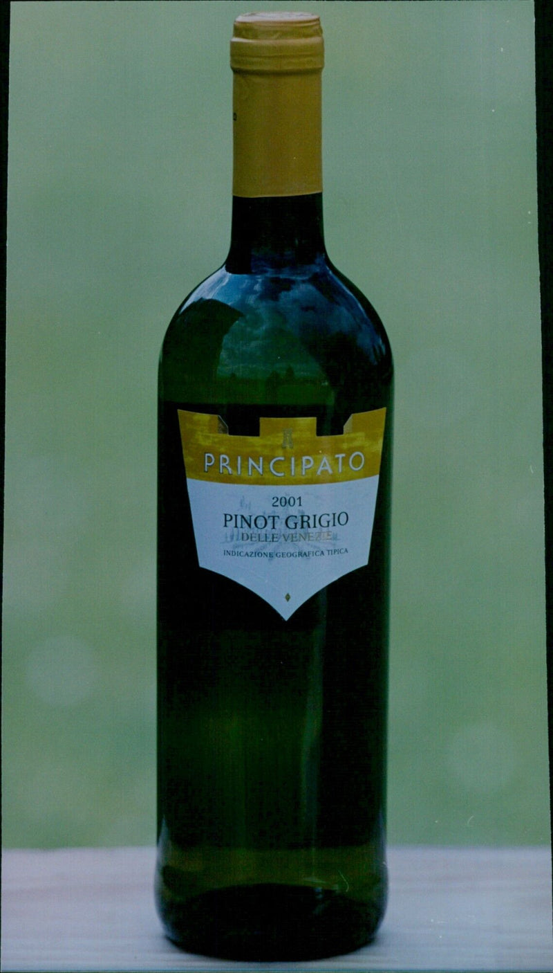 Andrew Chapman, owner of Drayton The Wine House, holds up a bottle of Principato 2001 Pinot Grigio delle Venezuel Indicazione Geografica Tipica. - Vintage Photograph