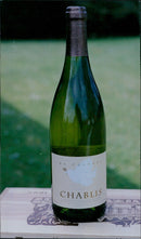 Andrew Chapman, owner of Drayton The Wine House, poses with bottles of La Colombe Chablis Appellation Chablis Conte 0 in Haywards Road, Drayton. - Vintage Photograph