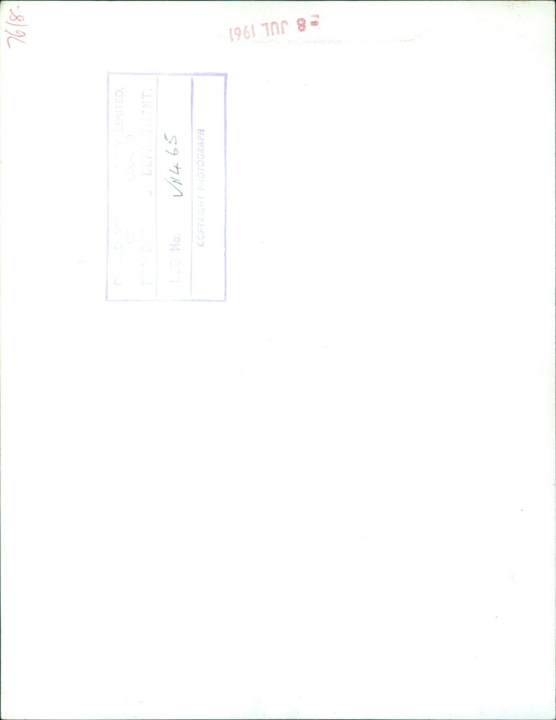 A man and woman enjoy a meal in a restaurant. - Vintage Photograph