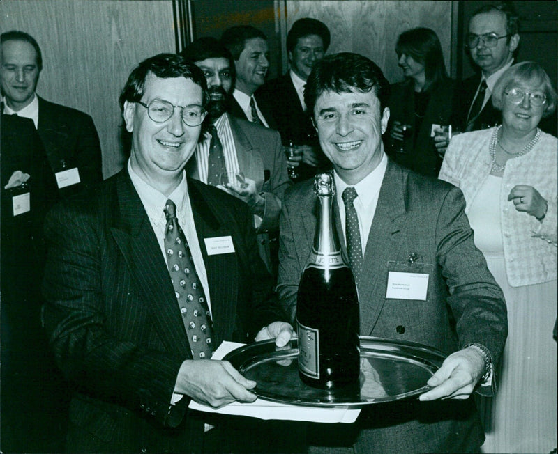 Tony Foulsham of Grant Thornton awards champagne to Brian Rowbotham of Regisbrook Group for their budget prediction. - Vintage Photograph