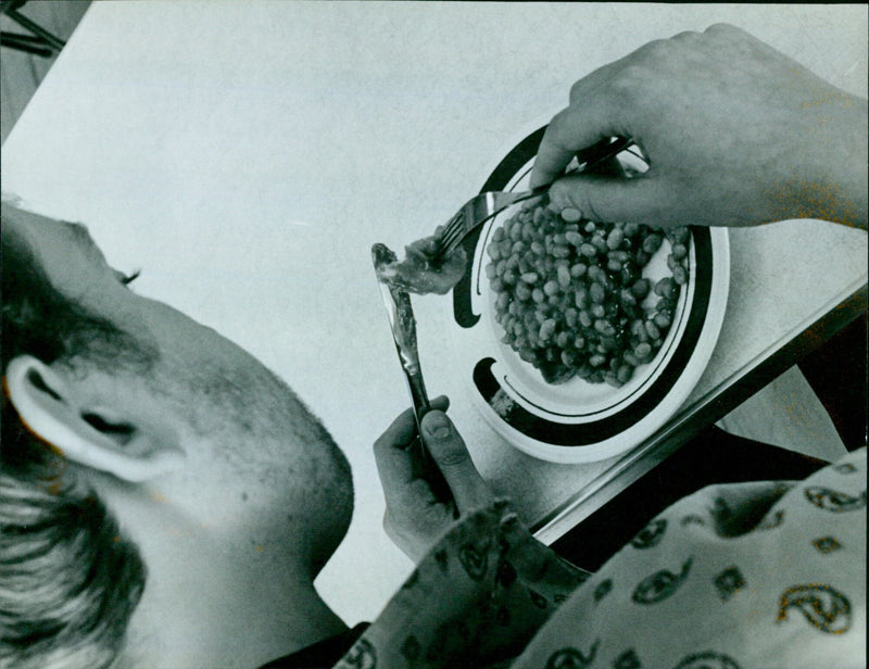 Students enjoying a meal of beans on toast in a student kitchen. - Vintage Photograph