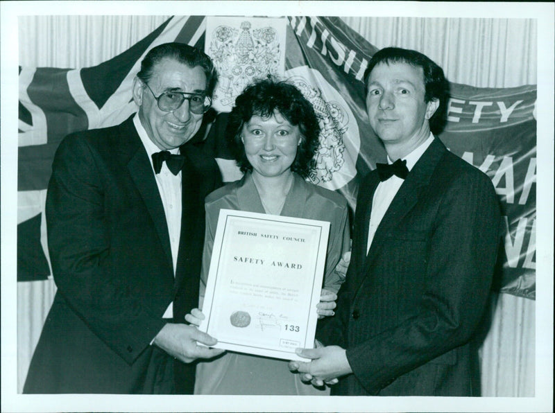 Mr James Tye, director general of the British Safety Council, presents an award for safety excellence to personnel manager Mr Malcolm Simmonds and his wife Mary. - Vintage Photograph