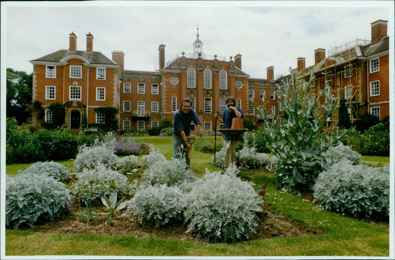 Lady Margaret Hall's Head Gardener Roger Cox and Ben Pritchard explore the gardens. - Vintage Photograph