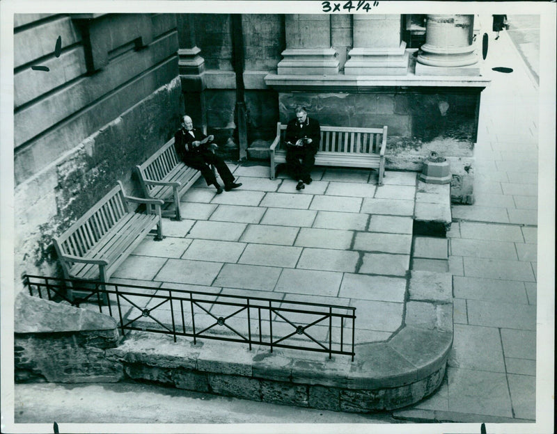 Three people in conversation at a table. - Vintage Photograph