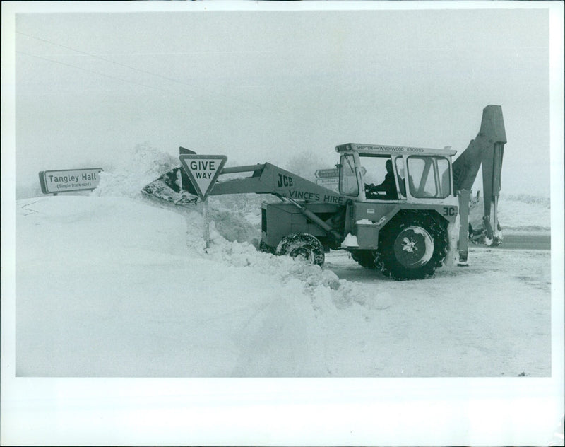 A JCB vehicle is approaching a single-track road in Tangley Hall, Wiltshire. - Vintage Photograph