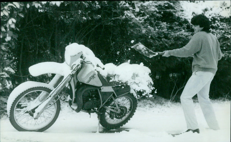 Clearing snow from a Yamaha motorcycle in Westlands, Abingdon. - Vintage Photograph