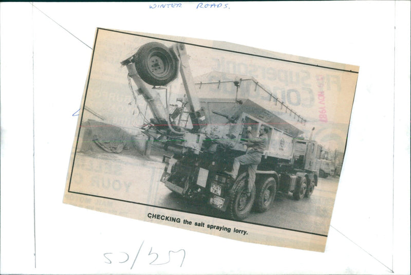 Salt spraying lorry being checked in winter conditions. - Vintage Photograph