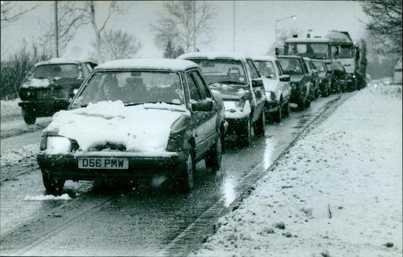 Cars navigate a wintery road in Oxford, MA. - Vintage Photograph