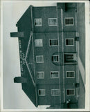 A group of men gather together on a sunny afternoon. - Vintage Photograph