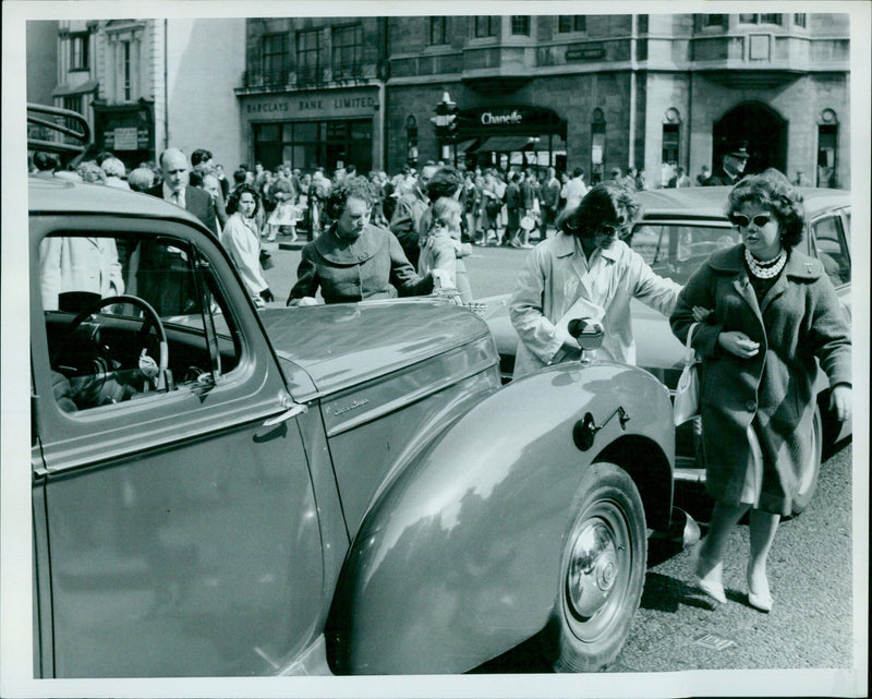 A woman holding a placard outside of Barclays Bank Limited in Oxford, England. - Vintage Photograph